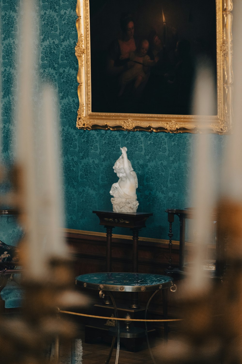 a room with blue walls and a painting on the wall