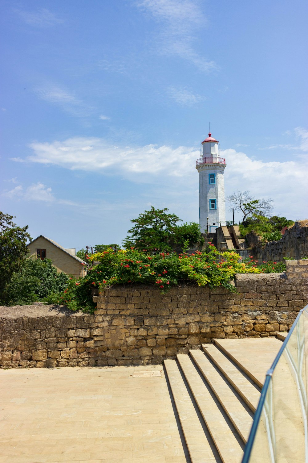 a light house sitting on top of a stone wall