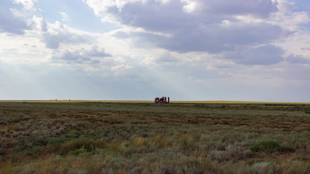 a tractor in a field with a sky background