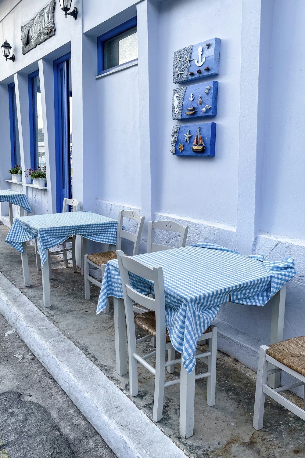 a row of blue and white tables and chairs