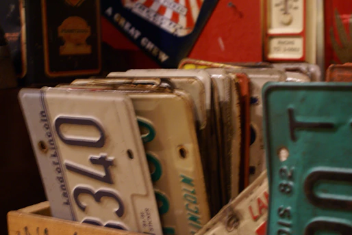 Federal vehicle plates and circulation cards neatly arranged on a wooden table.