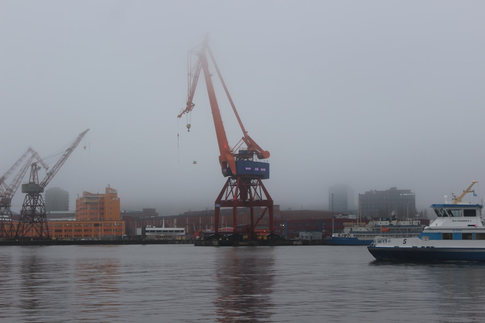 a boat in the water with a crane in the background