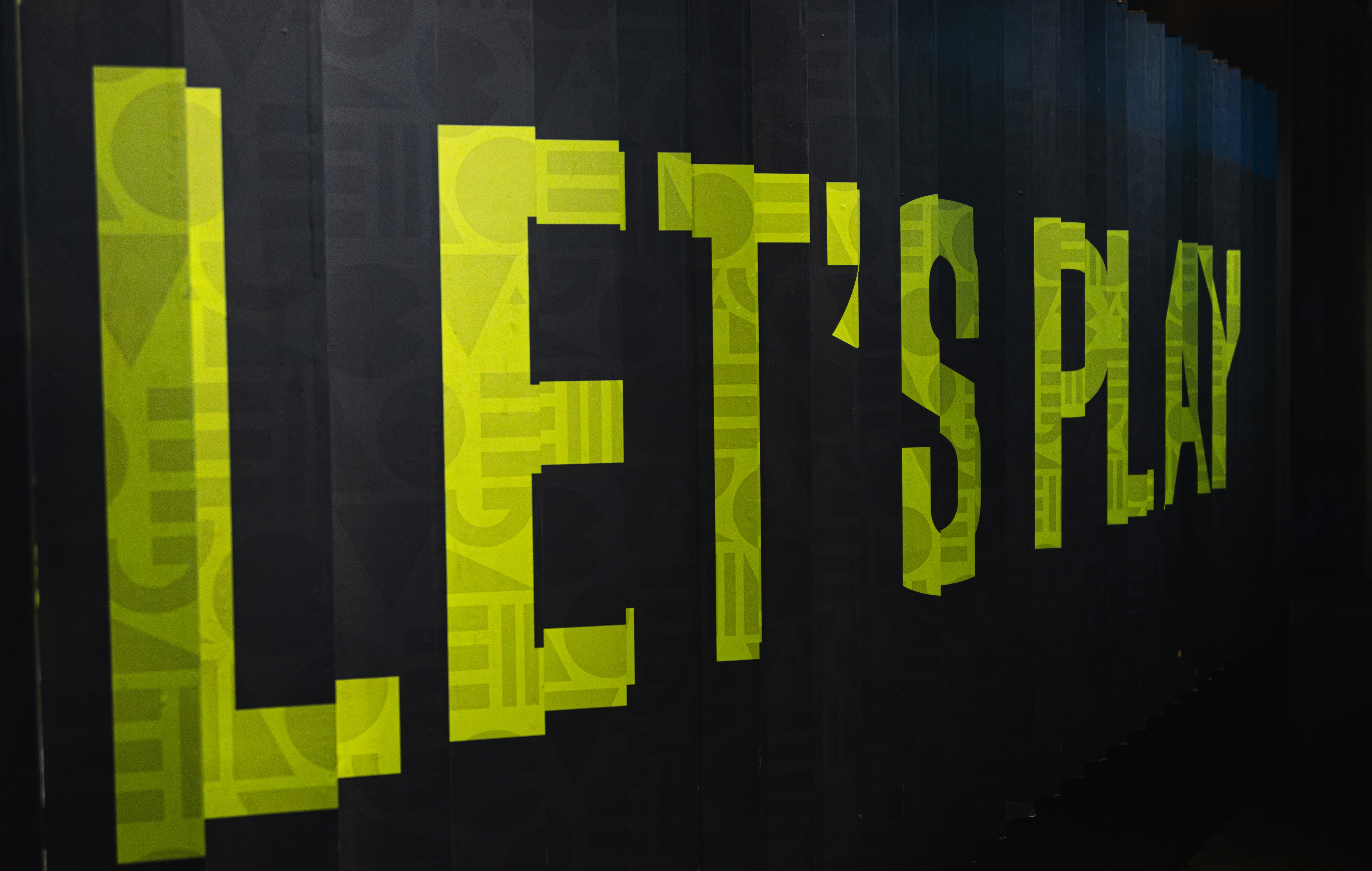 a black wall with yellow letters on it