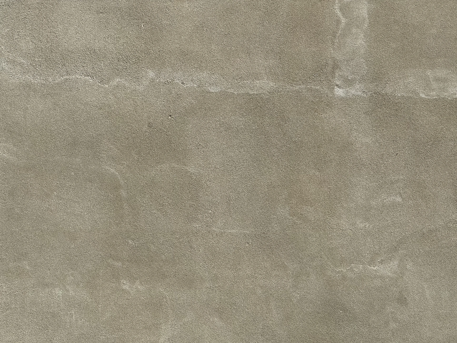 a gray concrete wall textured with light gray paint
