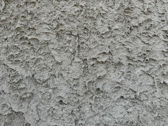a close up of a cement wall with cracks