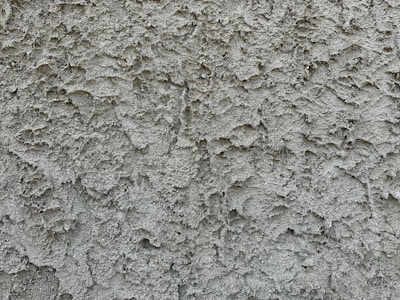a close up of a cement wall with cracks