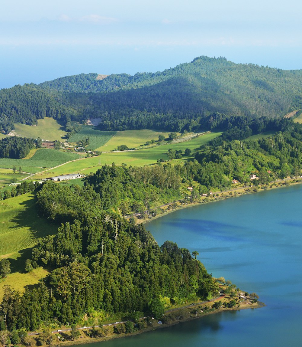 a large body of water surrounded by lush green hills