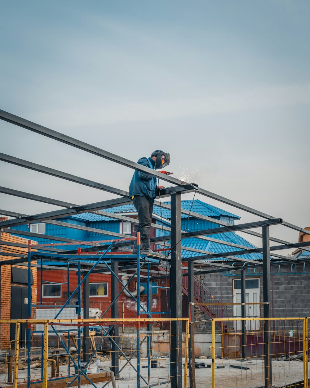 a man on a scaffold working on a building