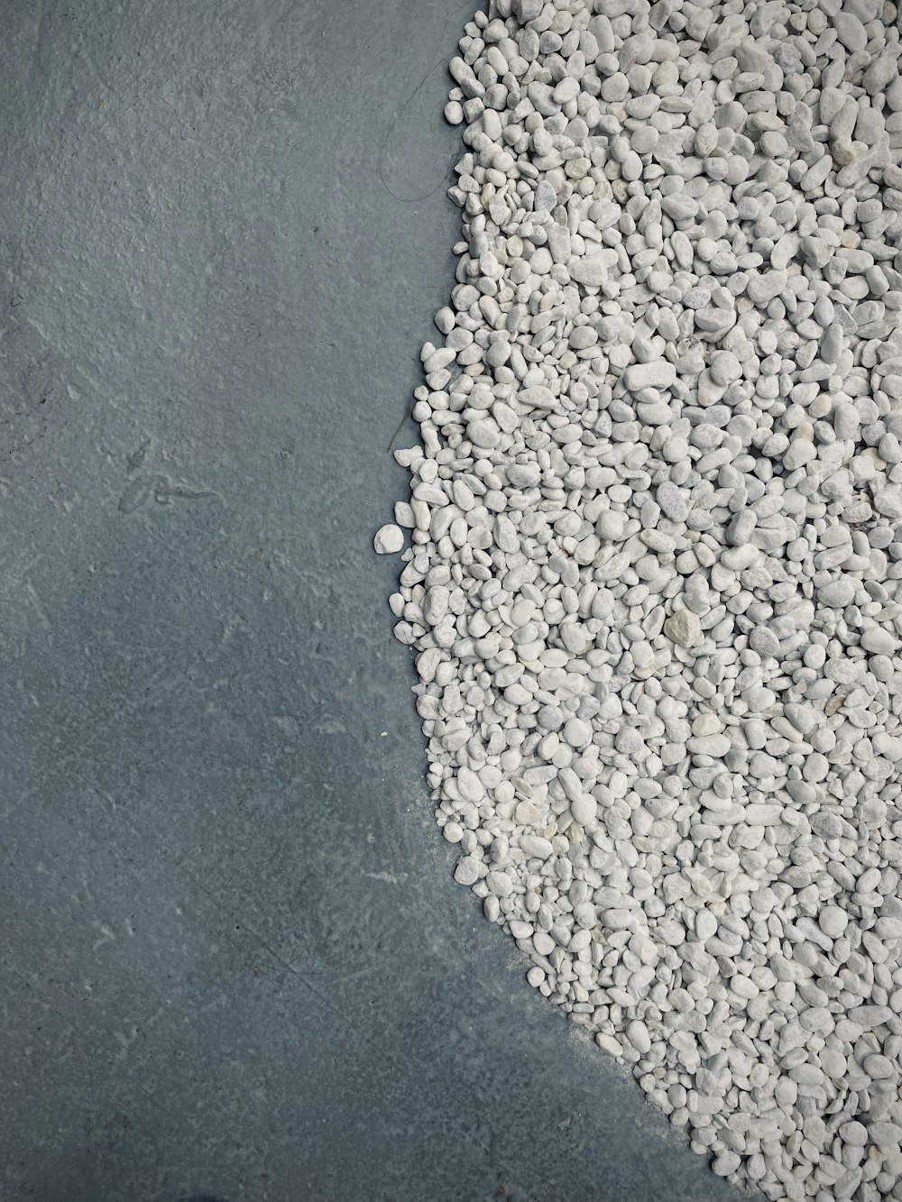 a pile of gravel sitting on top of a cement floor