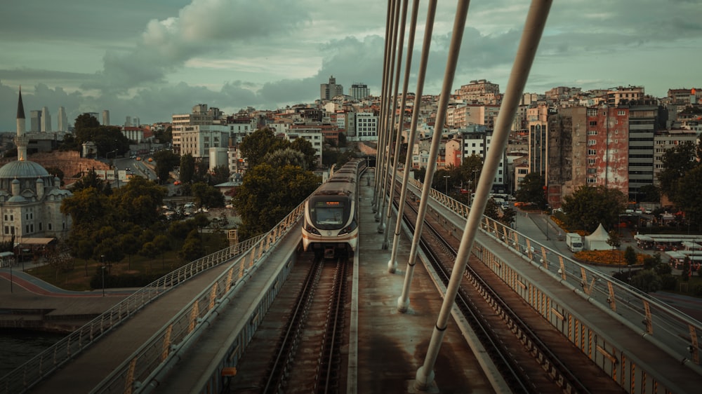 a train on a train track with a city in the background