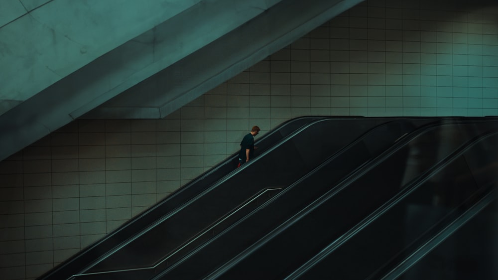 a man standing on an escalator in a subway station