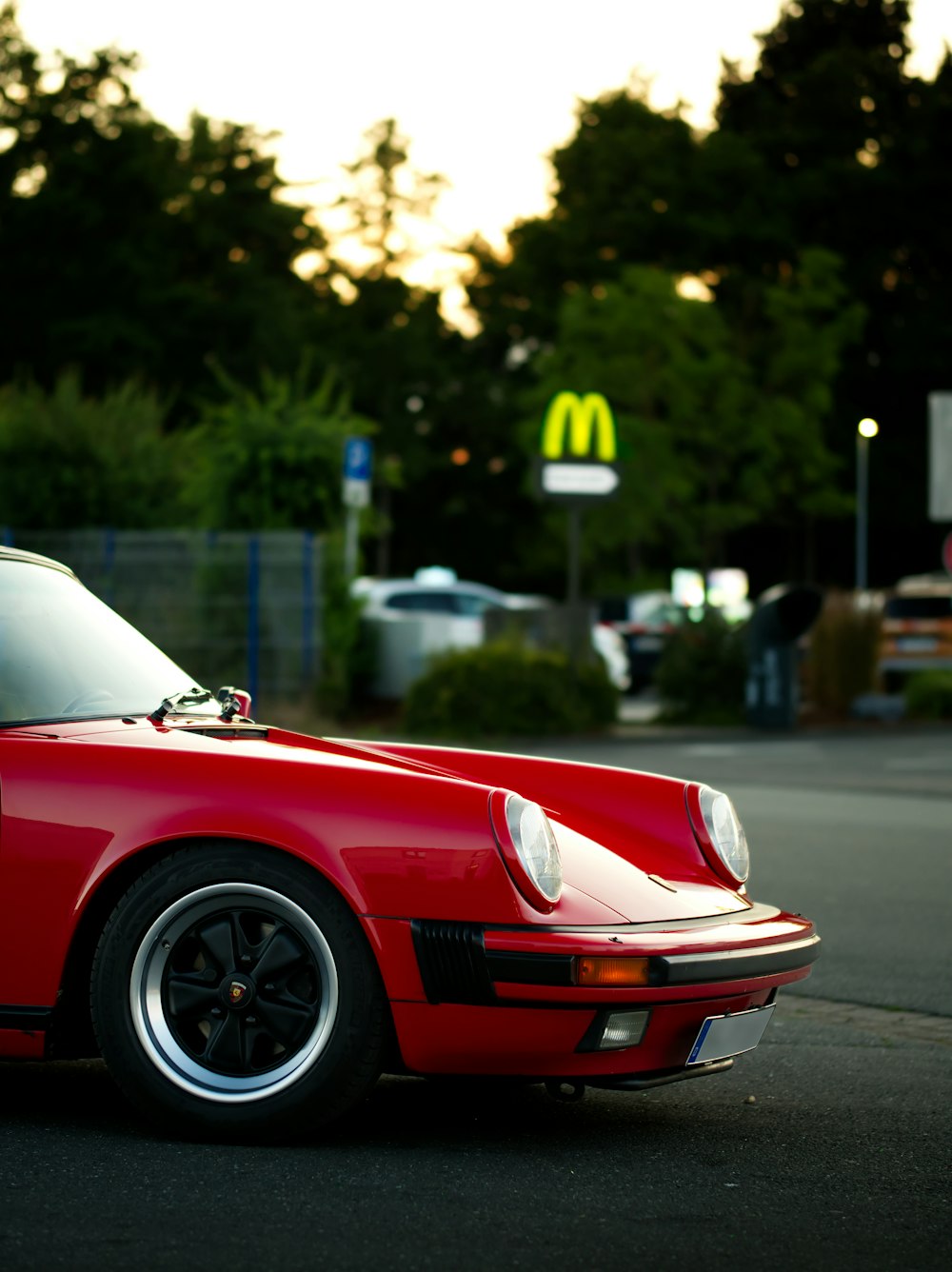 a red sports car parked on the side of the road