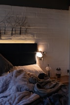 A cozy bedroom scene featuring a comfortable mattress with black and gray tones