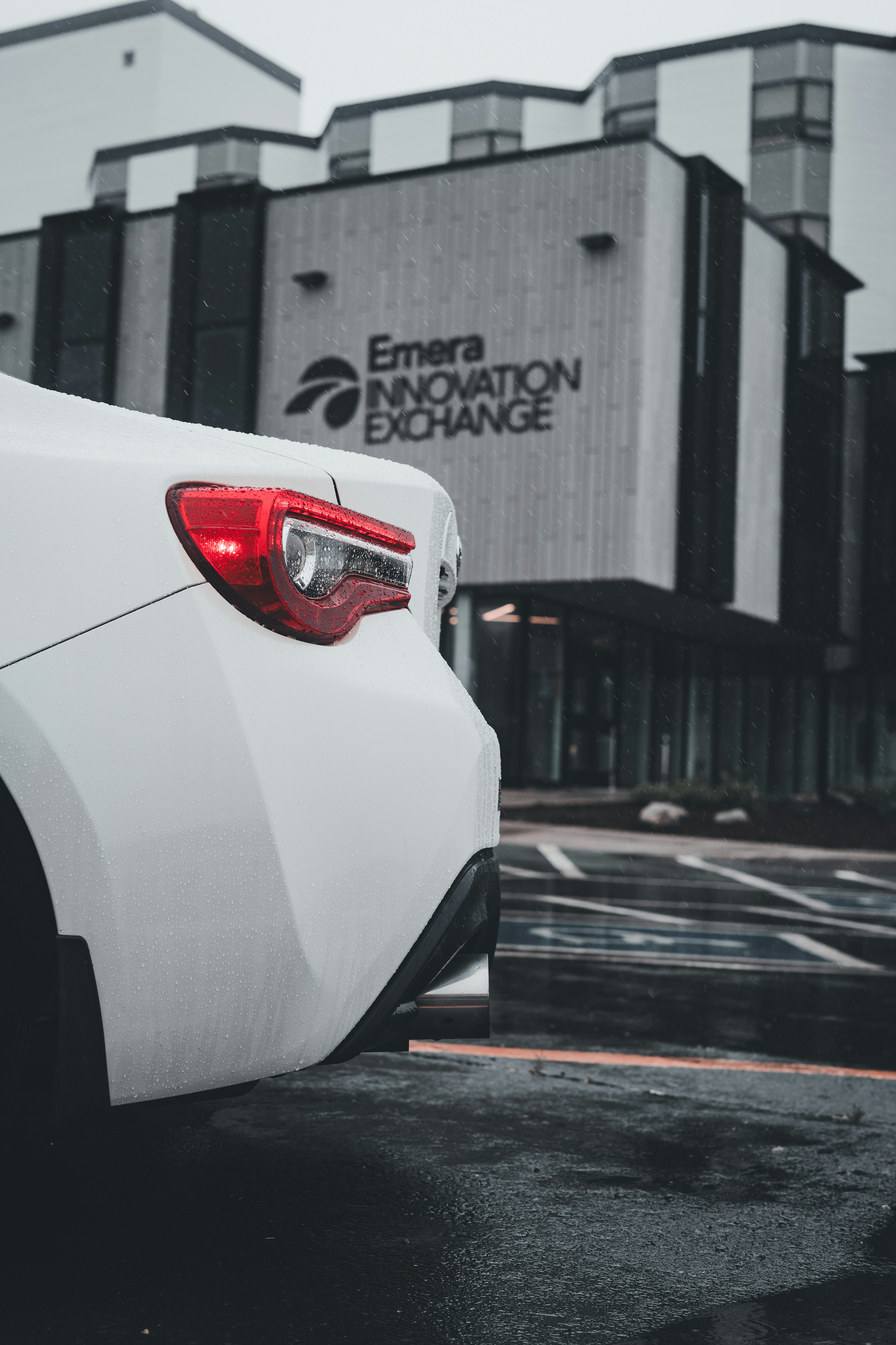 a white car parked in front of a building