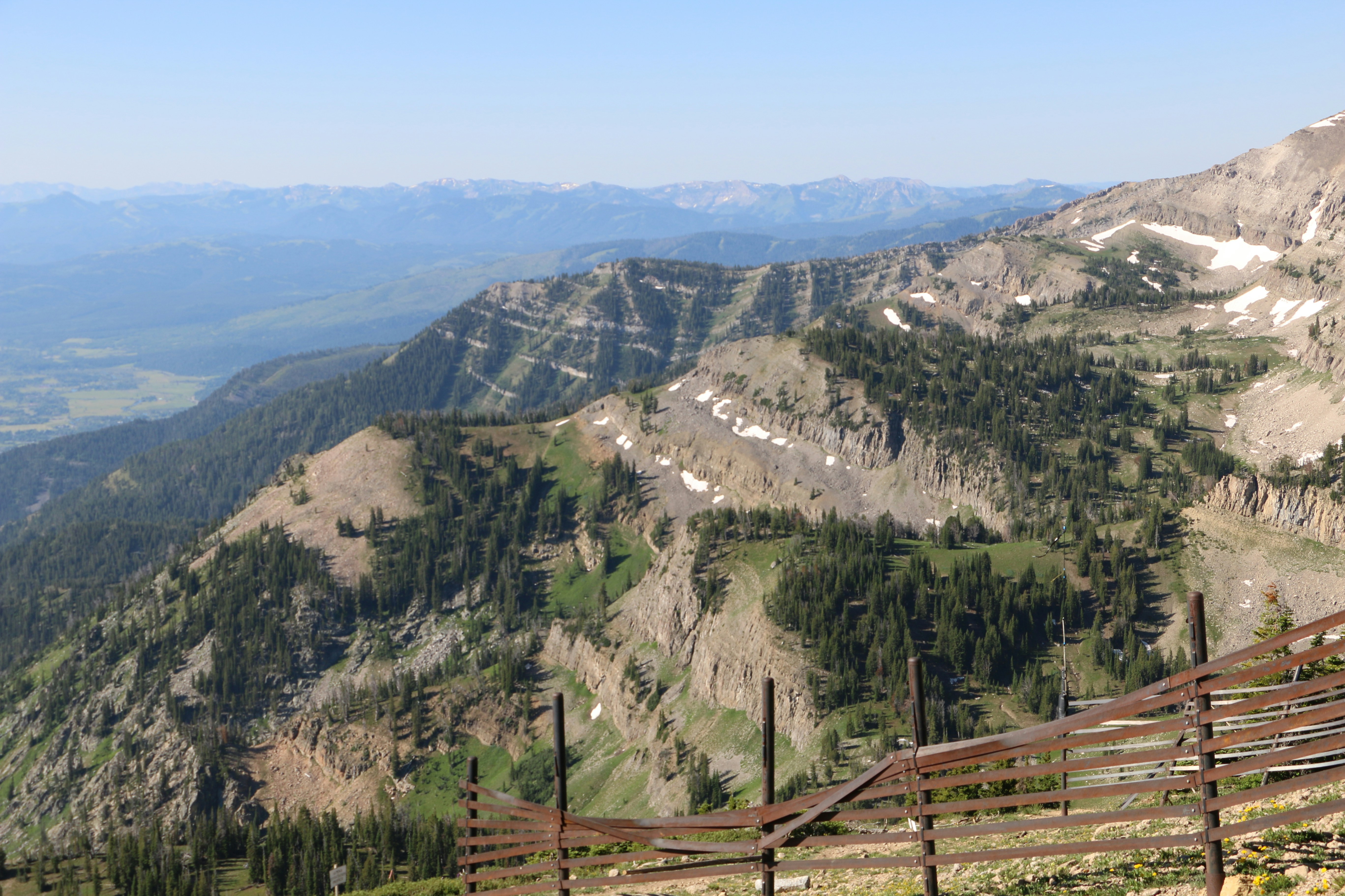 a wooden fence on the side of a mountain
