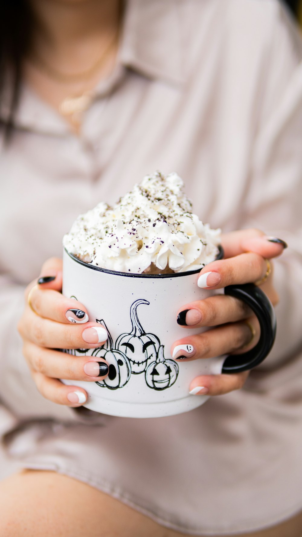 a woman holding a cup of whipped cream