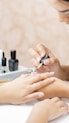a woman is doing a manicure on a child's hand