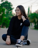 a woman sitting on the ground with her legs crossed