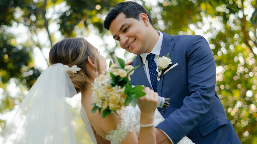 a bride and groom are smiling at each other