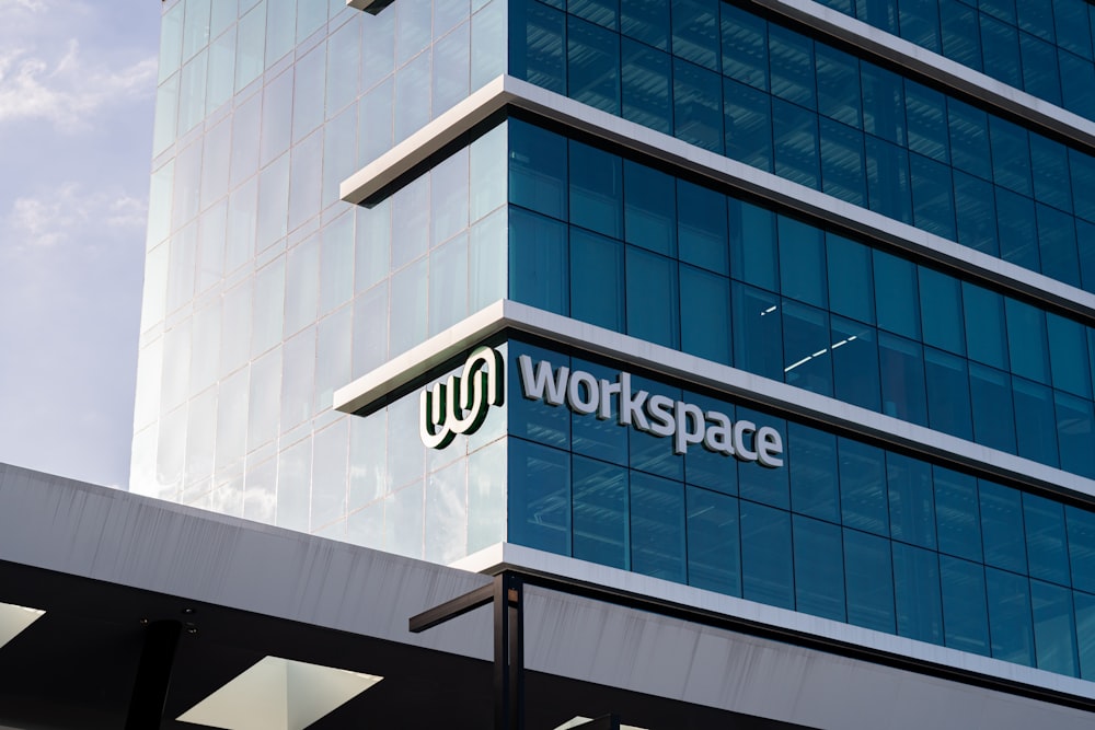 a large glass building with the words workspace on it