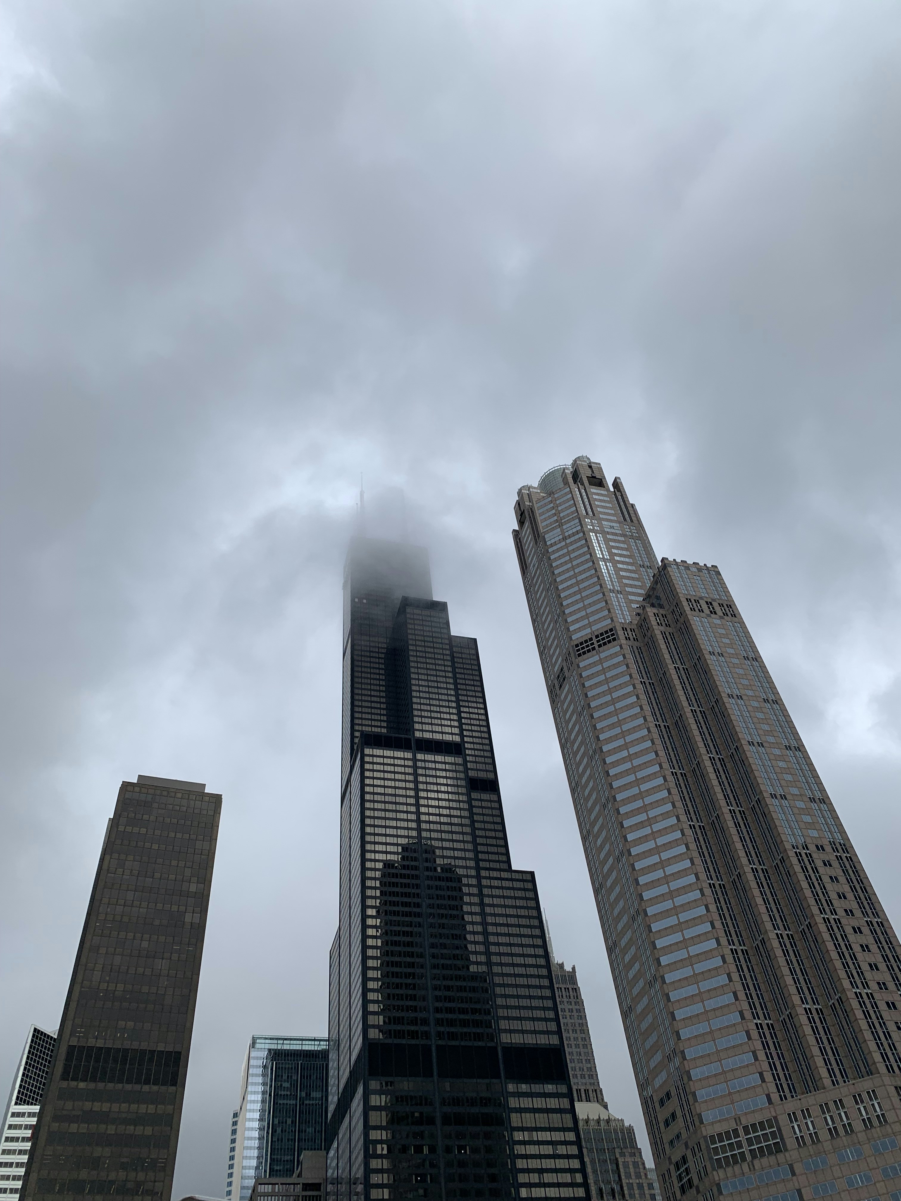 A group of tall buildings under a cloudy sky photo – Free Image on Unsplash
