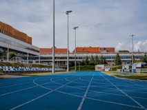an empty basketball court in front of a building