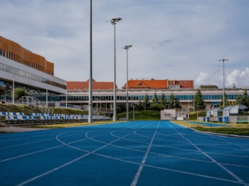 an empty basketball court in front of a building