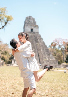 A joyful family posing together at the base of the Pyramid of the Sun, smiles wide and faces glowing.