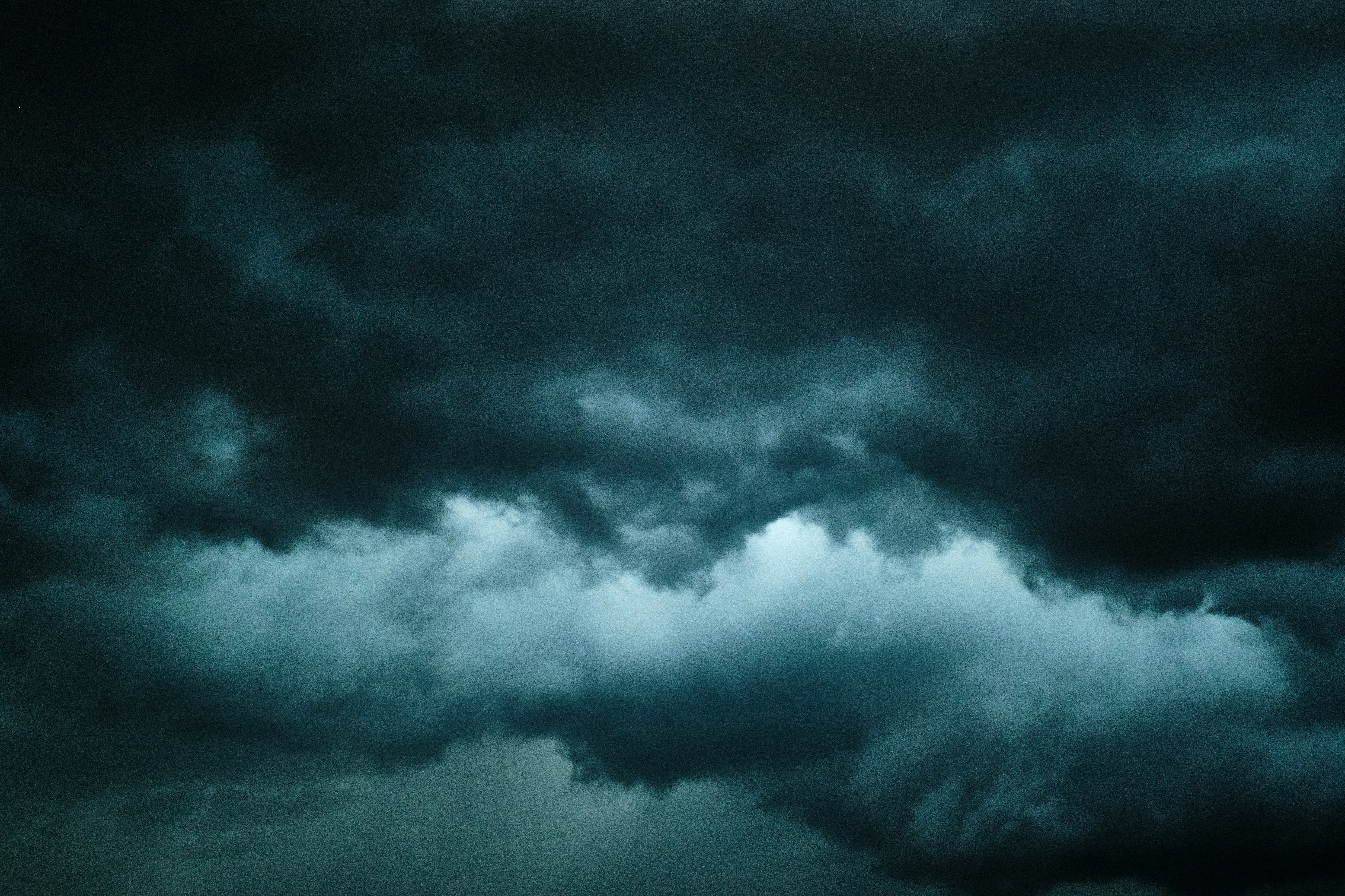 a plane flying through a dark cloudy sky