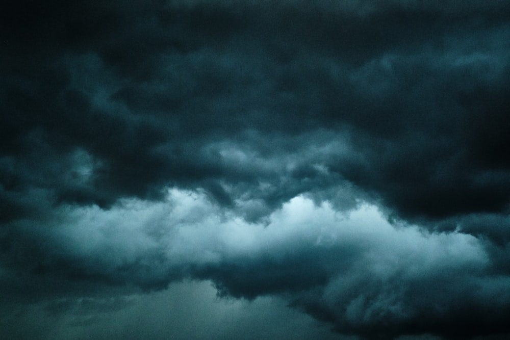 a plane flying through a dark cloudy sky