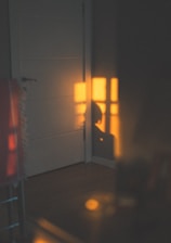 Soft morning light filtering through a serene meditation room with deep navy and golden accents.