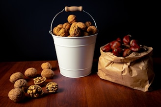 A basket filled with freshly picked Kishtwar Gold walnuts resting on rustic wooden farm table.