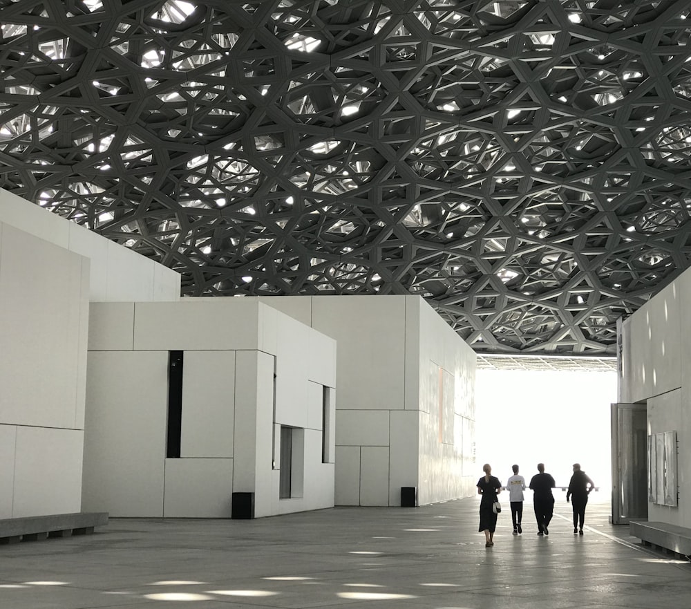 a group of people walking through a large building