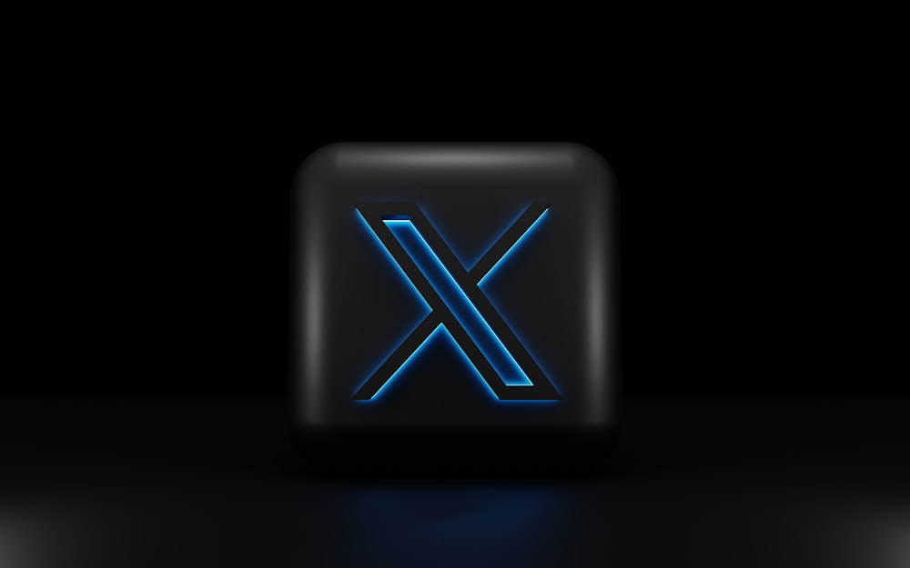 Una letra X iluminada azul sobre un fondo negro