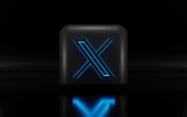 A sleek, modern workspace with a glowing red 'x' logo on a minimalist black and white background.