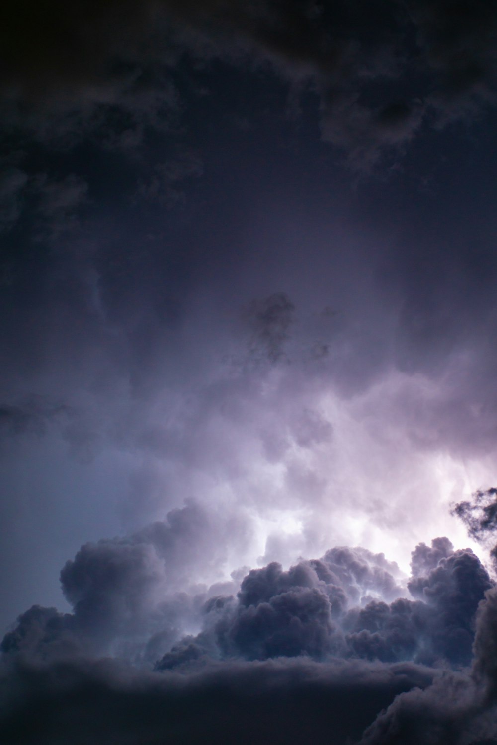 a plane flying through a dark cloudy sky