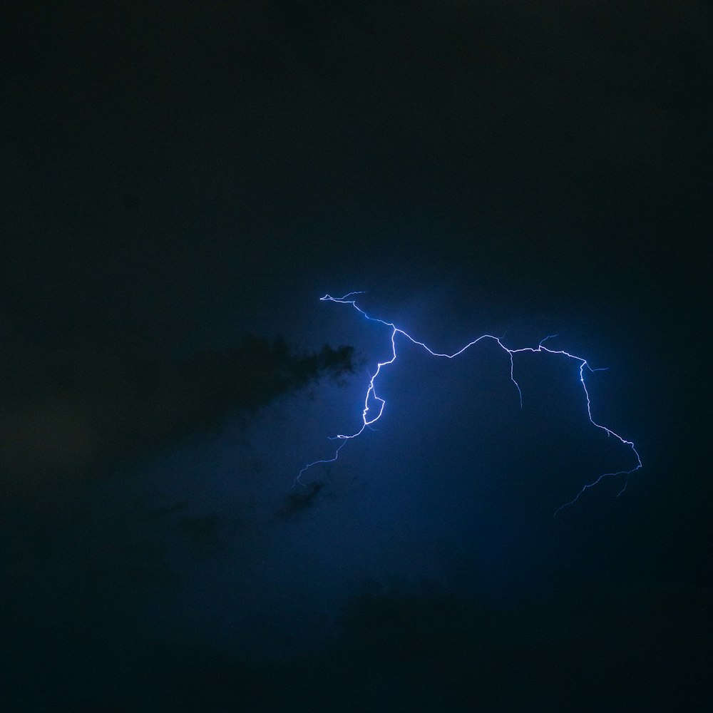 a lightning bolt hitting through the night sky