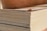 Close-up of stacked plywood sheets in a warehouse setting.