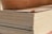 Close-up of stacked plywood sheets in a warehouse setting.