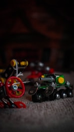 Tiny construction equipment keychains displayed on a metal workbench.