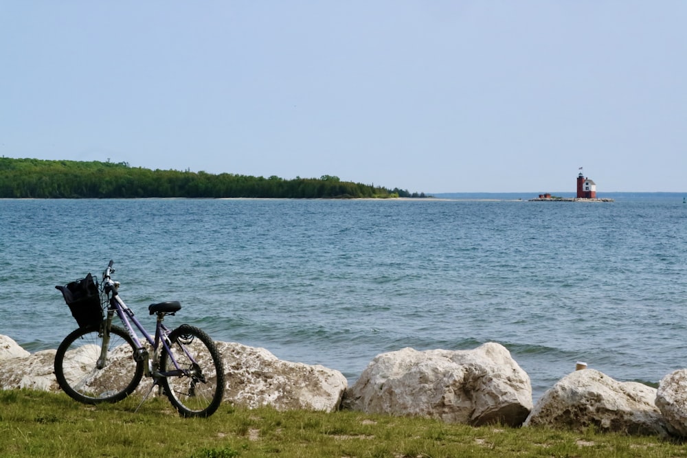 a bike parked next to a large body of water