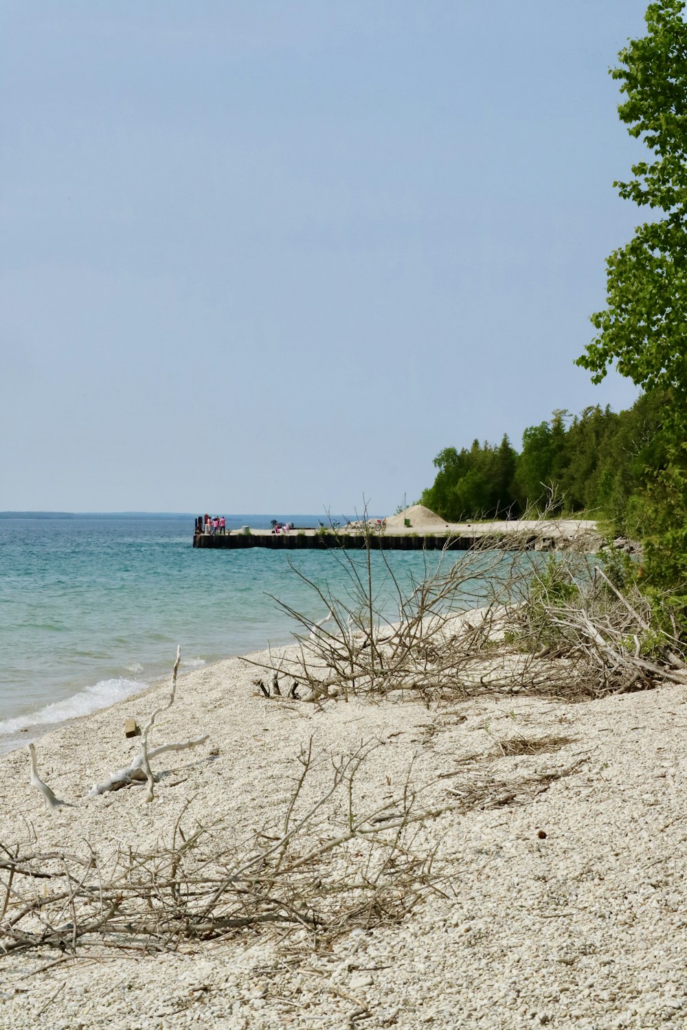 a sandy beach next to a body of water