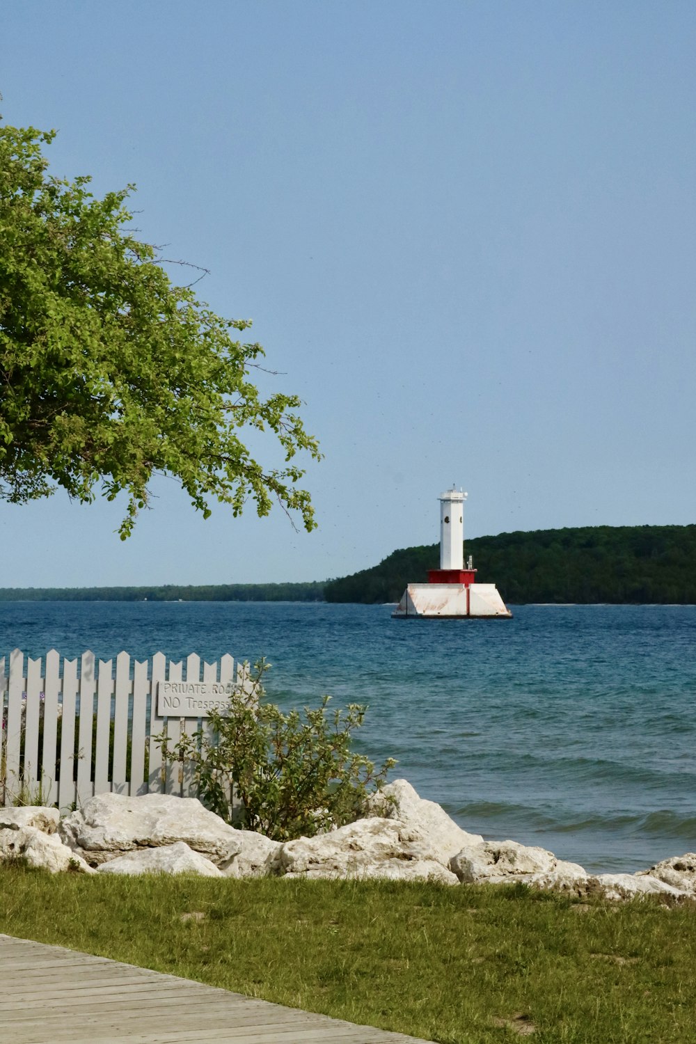 a lighthouse on a small island in the middle of the ocean