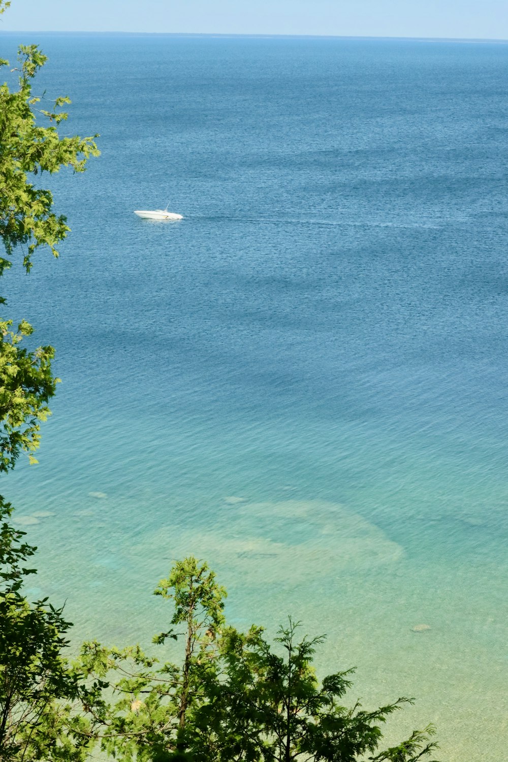 a boat is out in the water near the shore