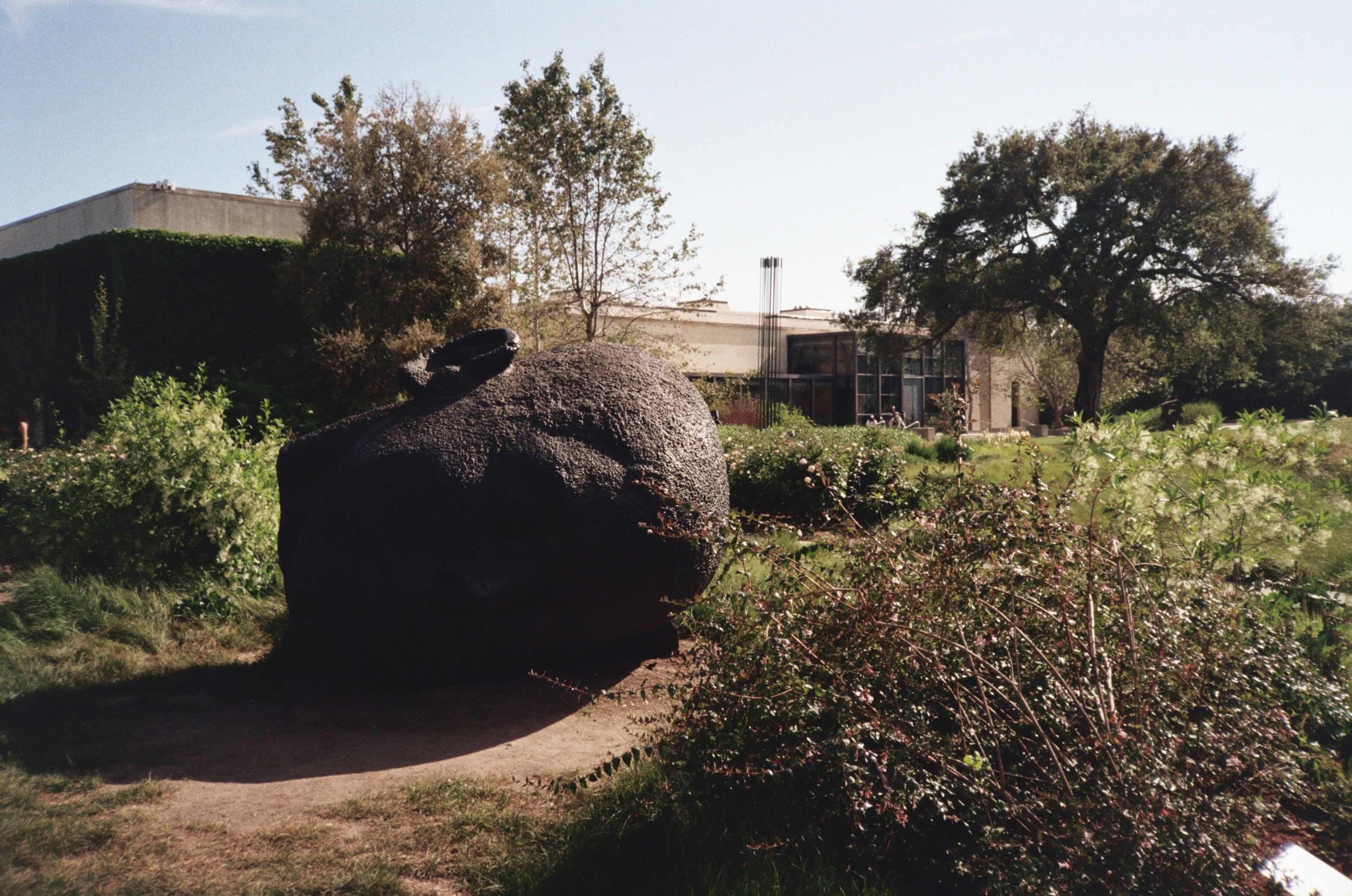 a large rock sitting in the middle of a field
