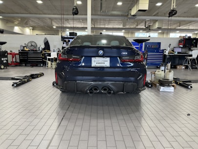 A skilled technician performing a detailed vehicle inspection in a clean, well-equipped garage.
