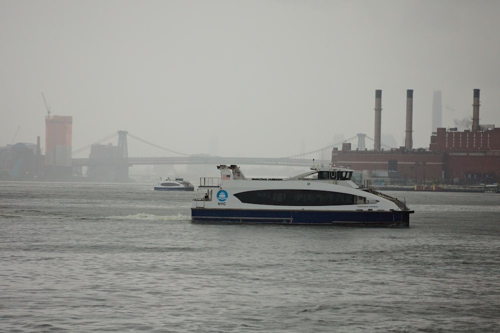 a white and blue boat in a body of water