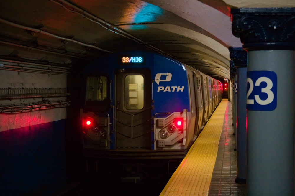 a train pulling into a train station next to a platform