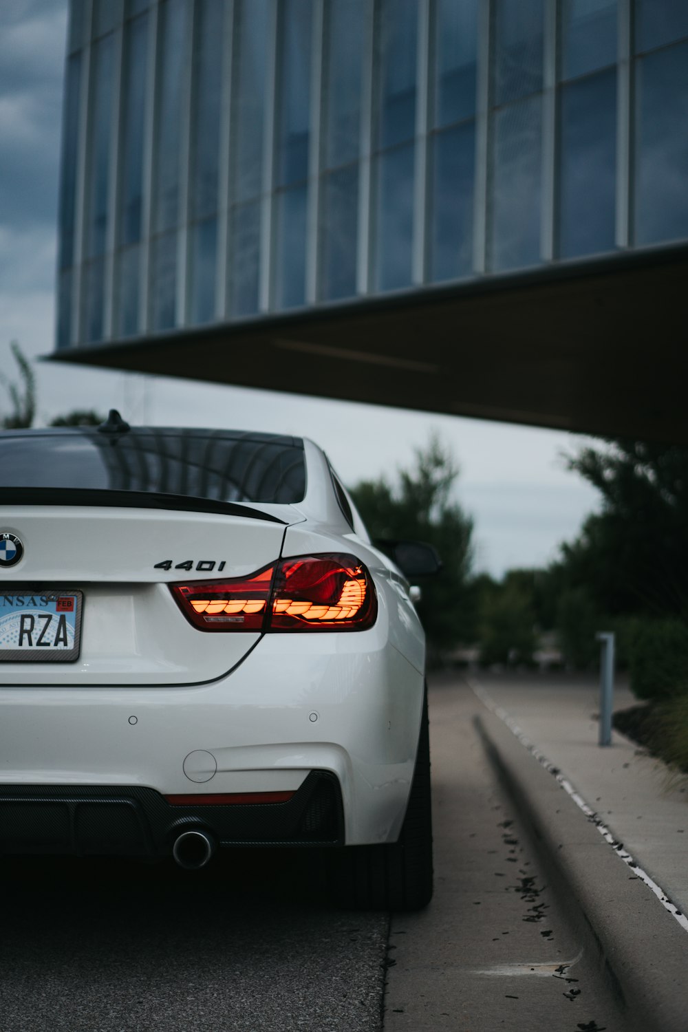 a white car parked in front of a building