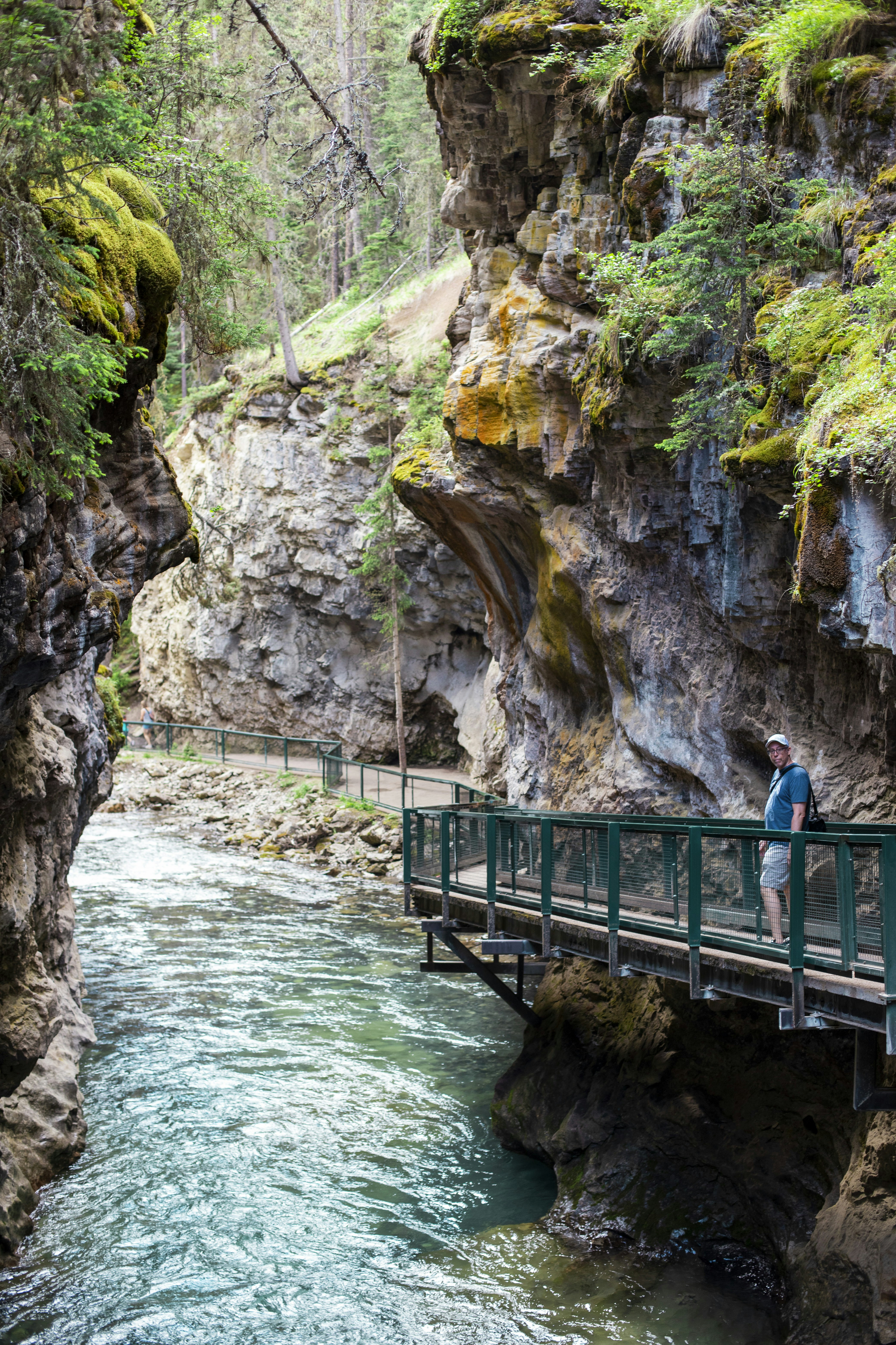 a man standing on a bridge over a river